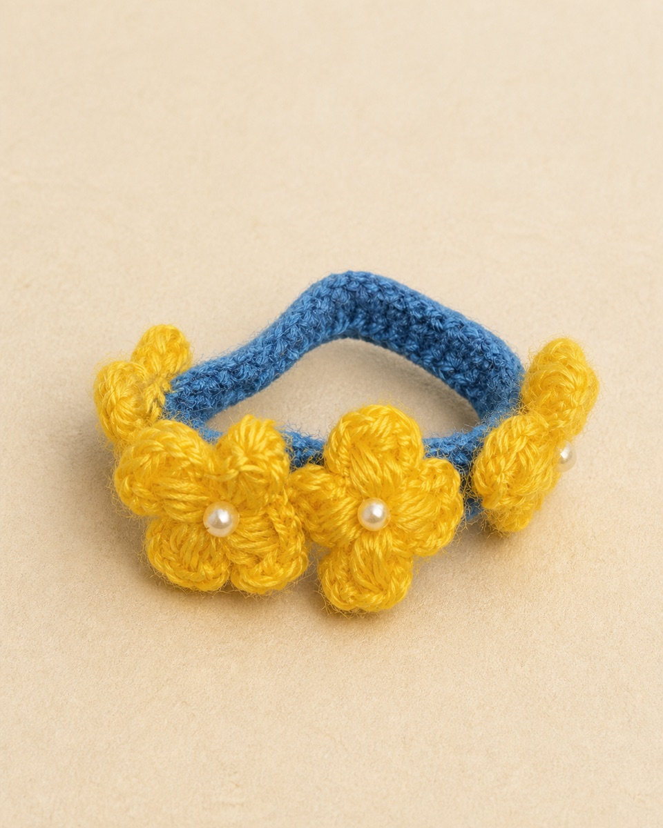 Dark blue crocheted loop with golden-yellow flower motifs and round white bead accents